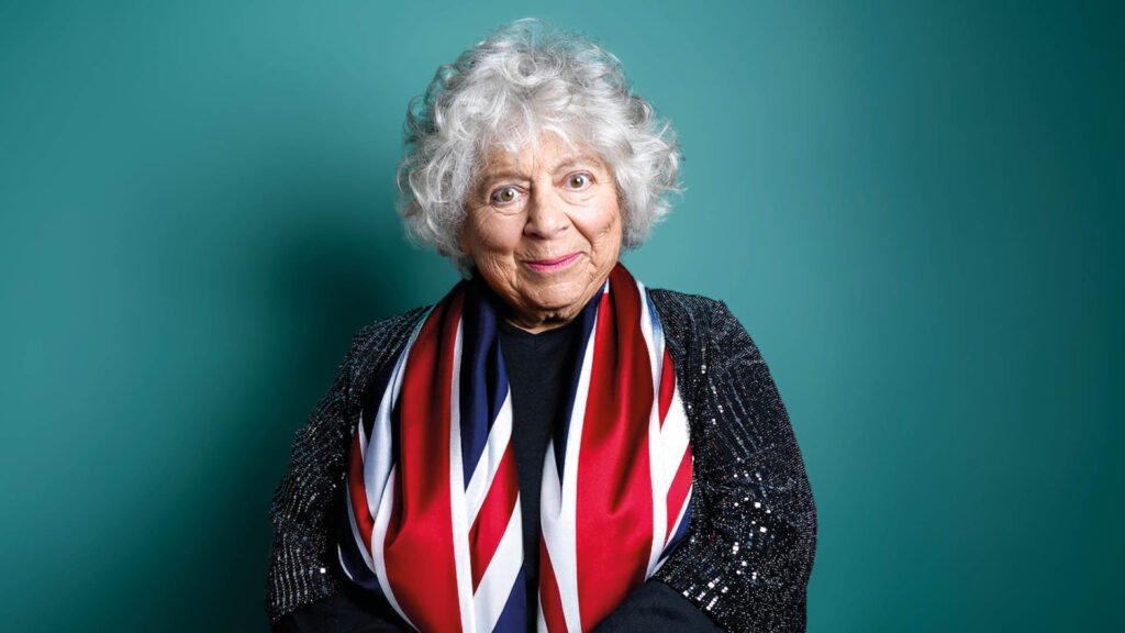 Photograph of Miriam Margolyes wearing a United Kingdom flag around her neck.