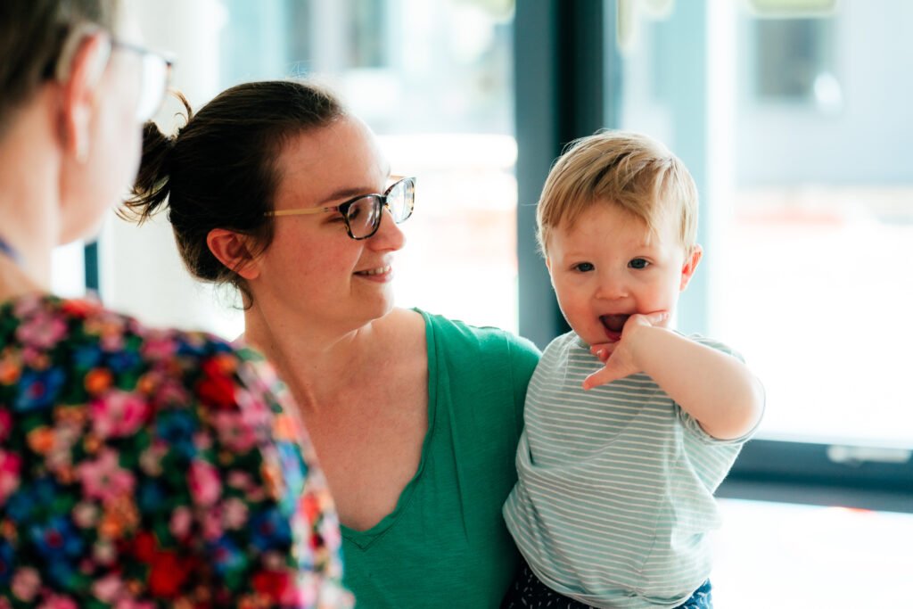 A parent is holding a baby
